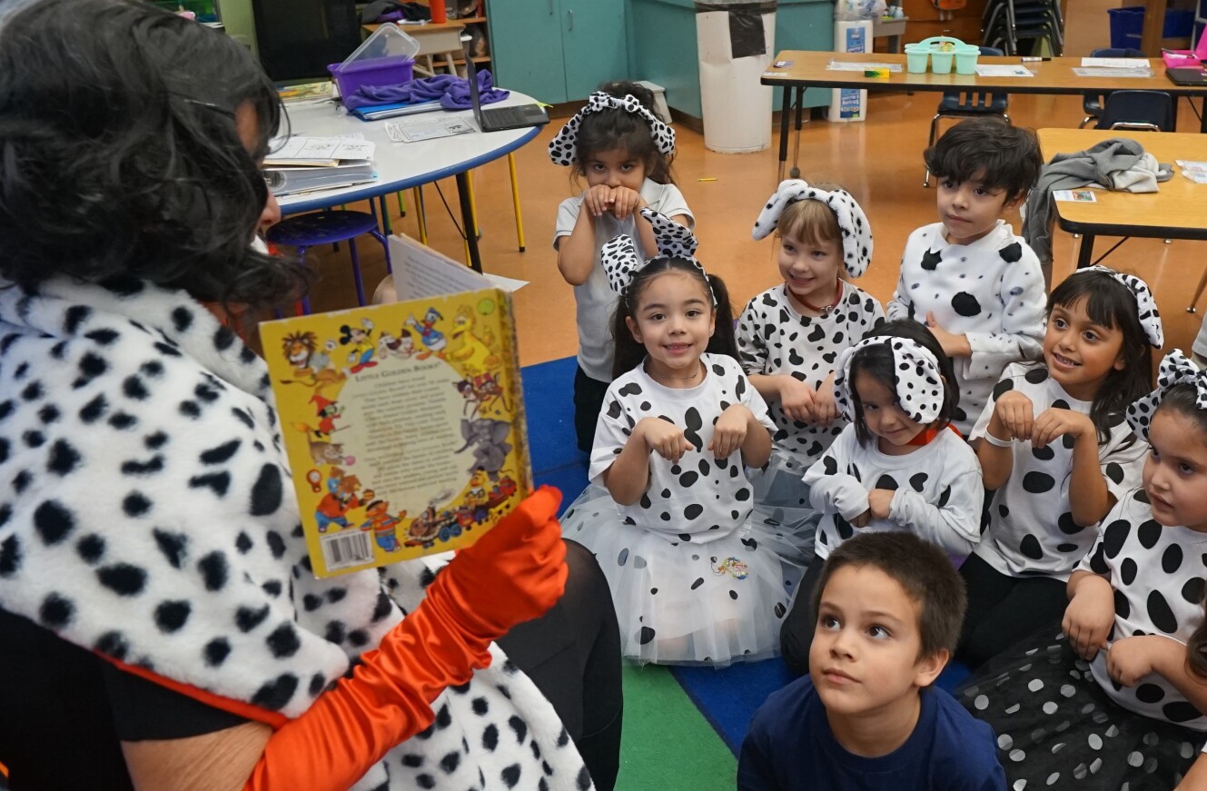 Students pose as Dalmatians during storytime